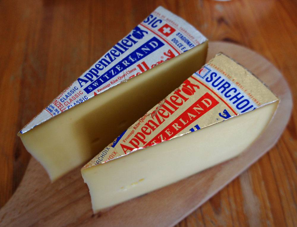 Two pieces of Appenzeller Cheese on the chopping board