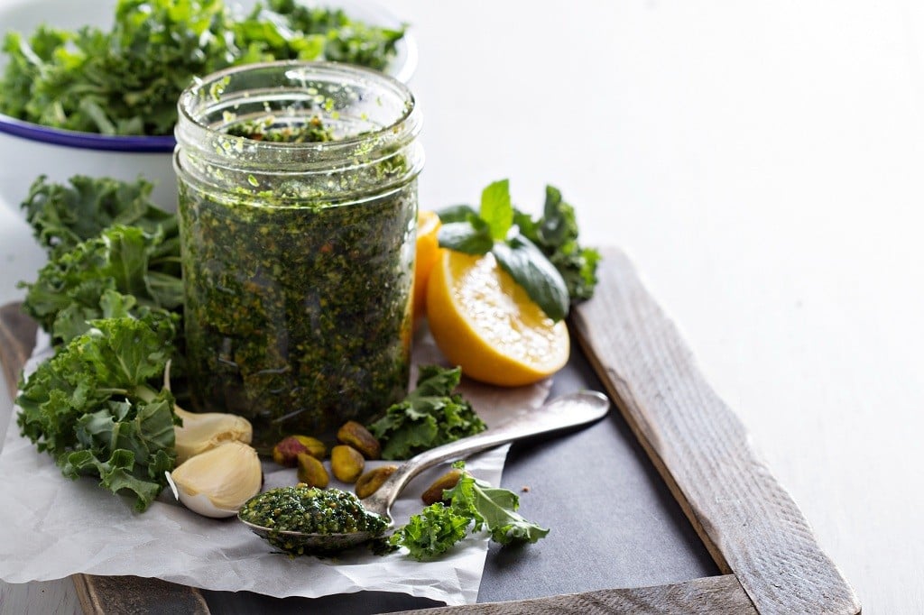 A bottle of A bowl of Kale Pesto, a bowl of Kale Pesto and a spoon of Kale Pesto 