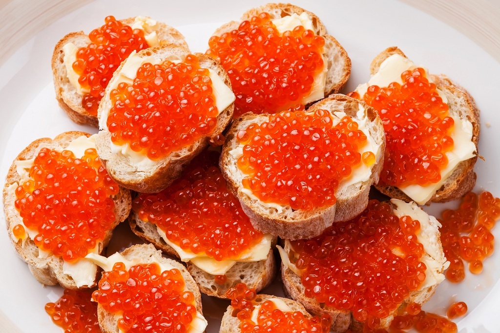 Pieces of bread with caviar and cheese