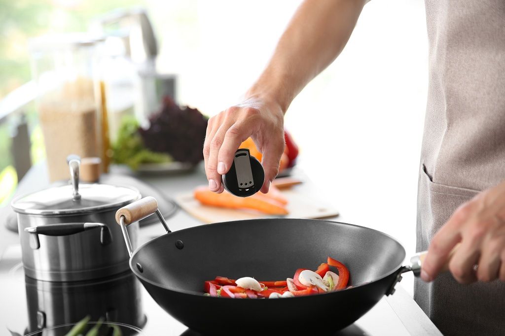 A man is cooking with Celery salt