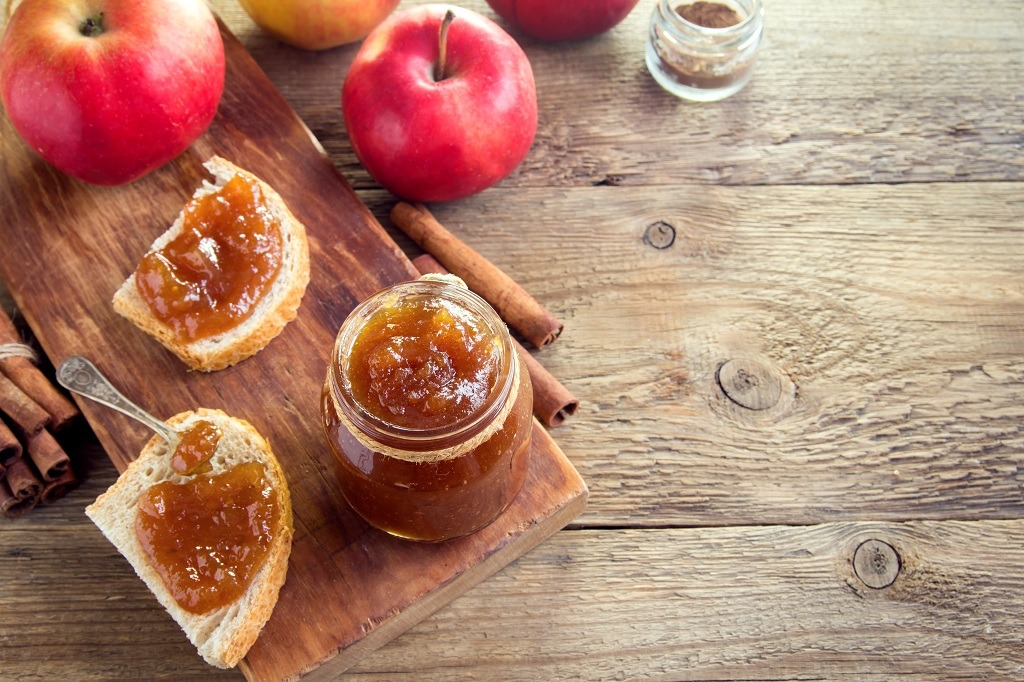 vegan butter, breads, apples, a spoon on the table