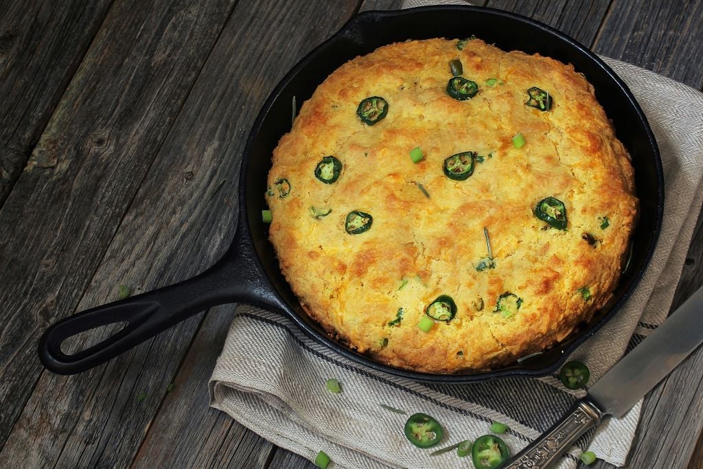 cornbread in the pan and a knife