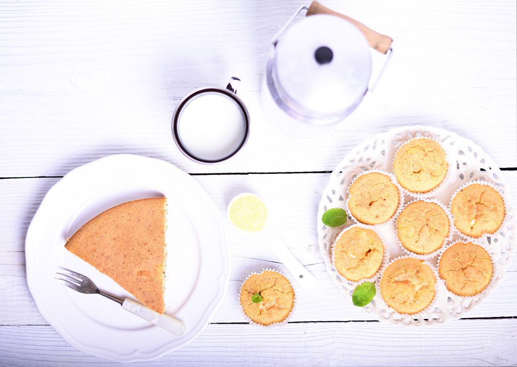 Cornbread and a fork on plate, milk and a plate of Cornbread