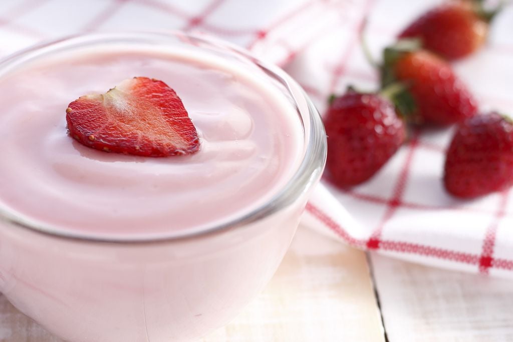 a bowl of strawberry whipped cream and strawberries