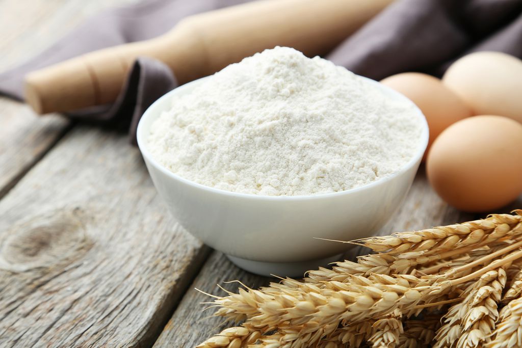 Barley, eggs and a bowl of Flour on the table