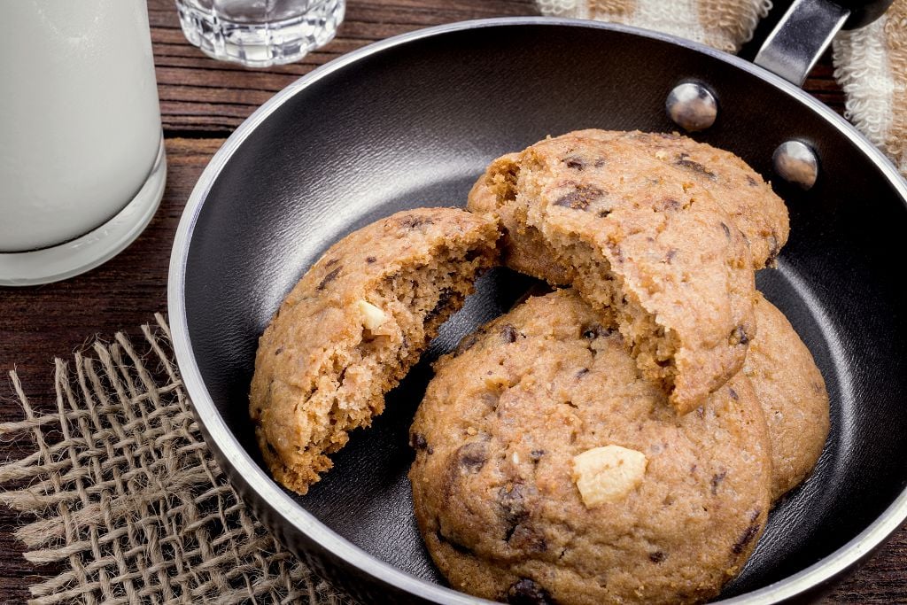  biscuits on the pan and a cup of milk