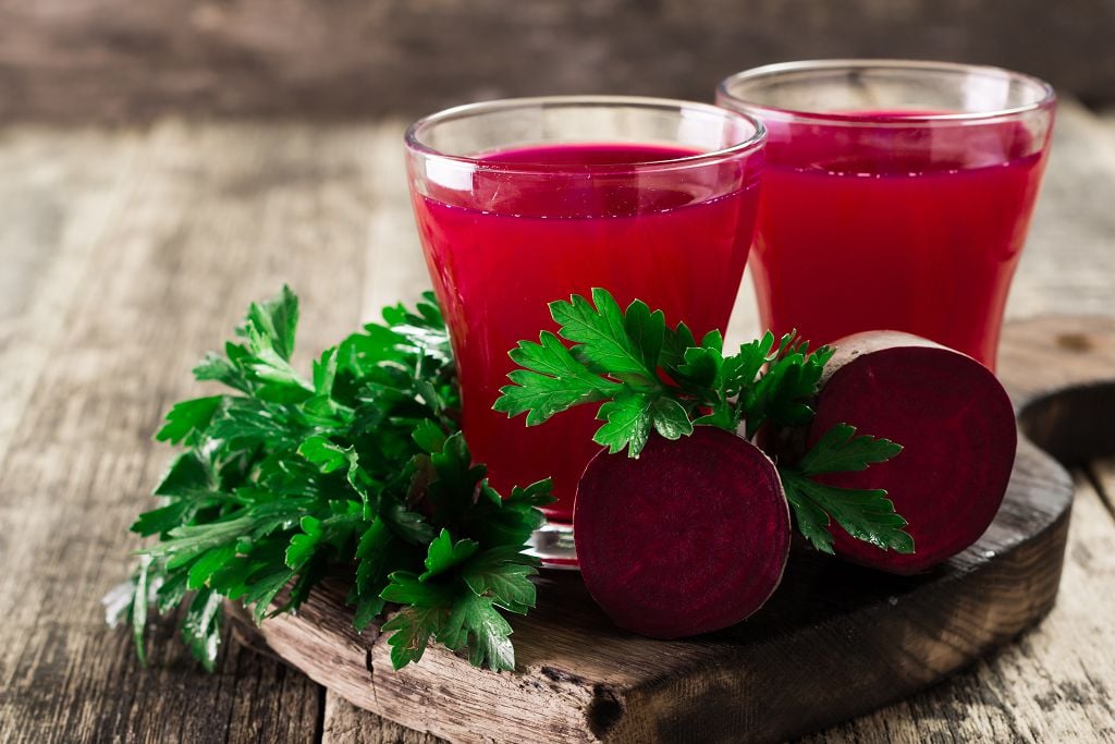 cups of Beetroot juice on the chopping board