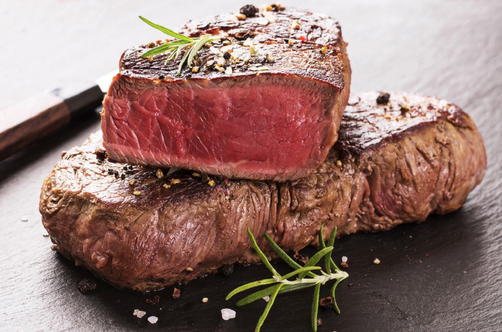 Slices of Beef Steak and tomatoes on the chopping board