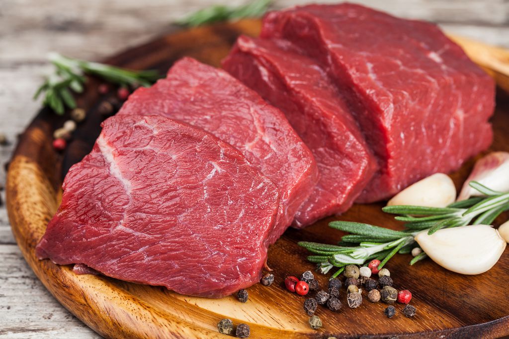 Beef Steak on the chopping board and vegetables