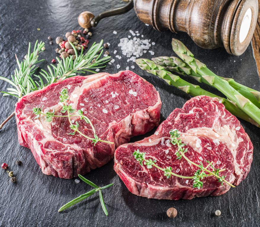 Slices of Beef Steak and asparagus on the table