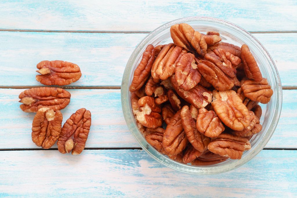  walnuts and a bowl of walnuts on the table