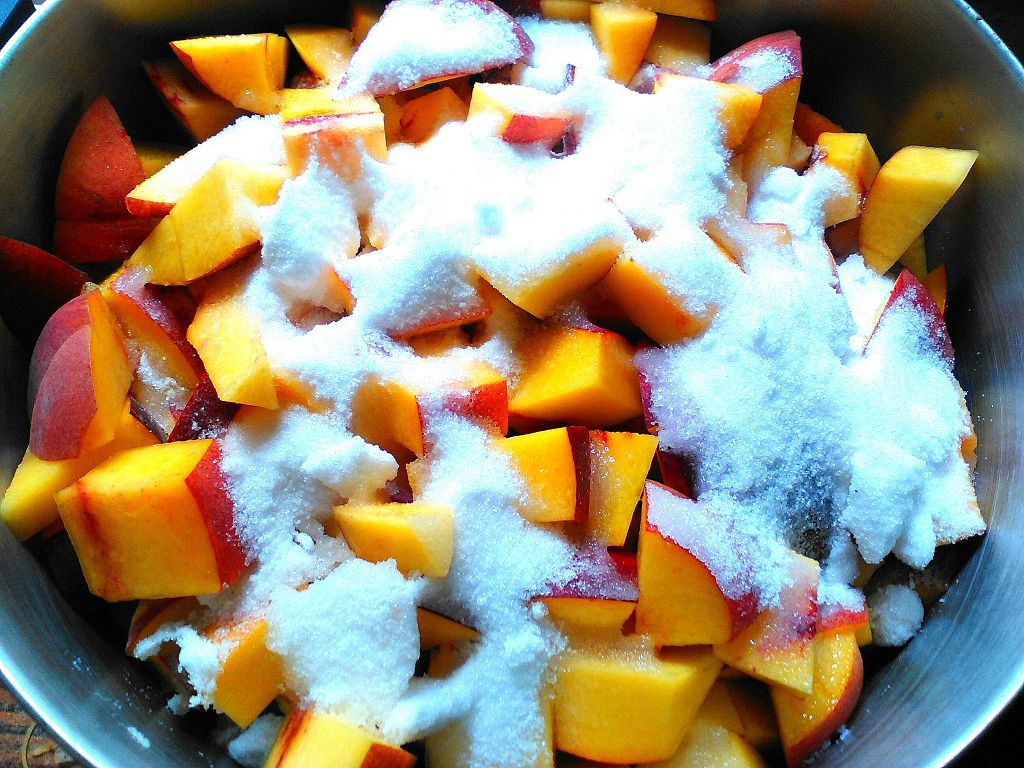 slices of Peach with sugar on the huge bowl