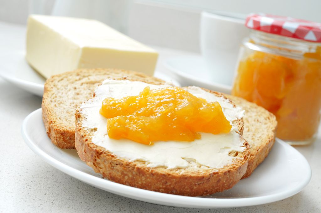 bread with peach jams and butter on the plate