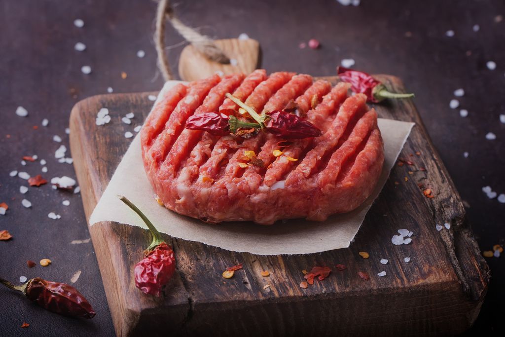 Burger Patties and chili pepper on the chopping board