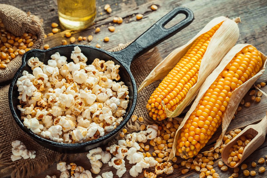 A pan of Popcorn Kernels and corns on the table