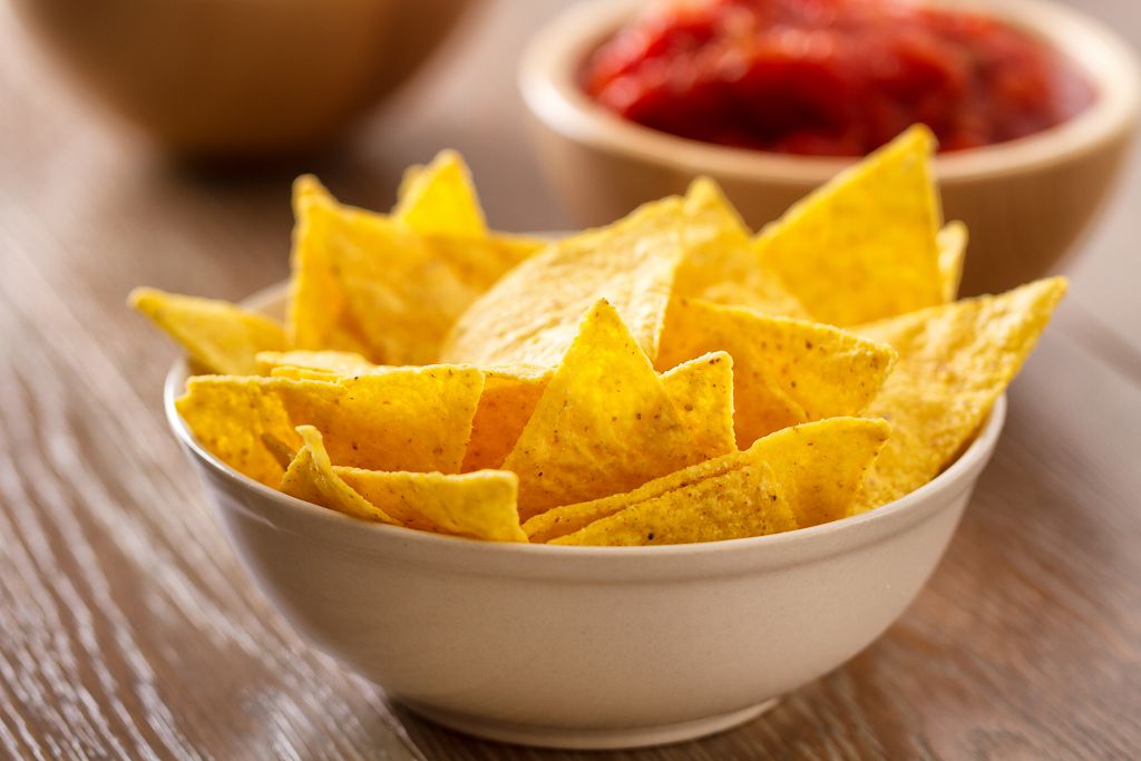 A bowl of tortilla chips on the table