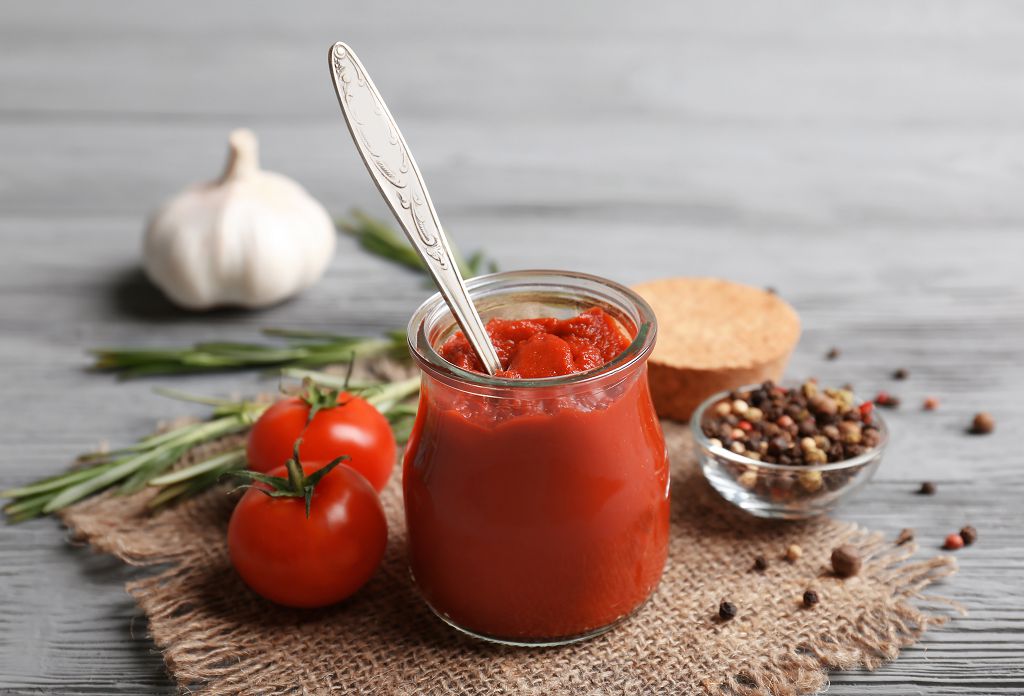 A jar of Mixing Tomato Paste and tomatoes