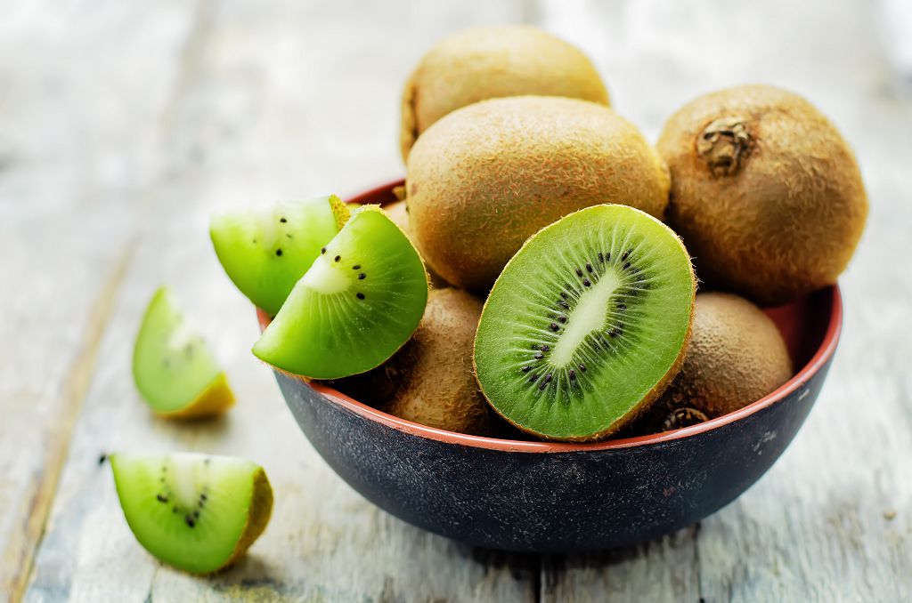 A huge bowl of kiwi on the table