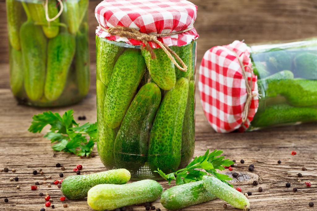 Bottles of pickles and pickles on the table