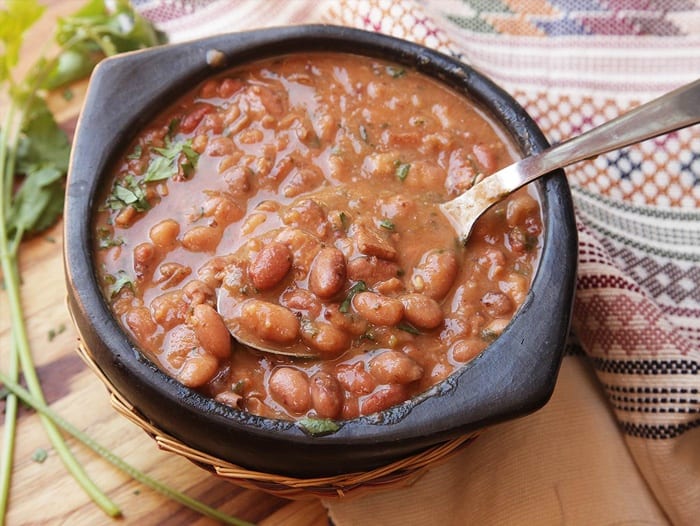 A bowl of Mexican Pinto beans and a spoon