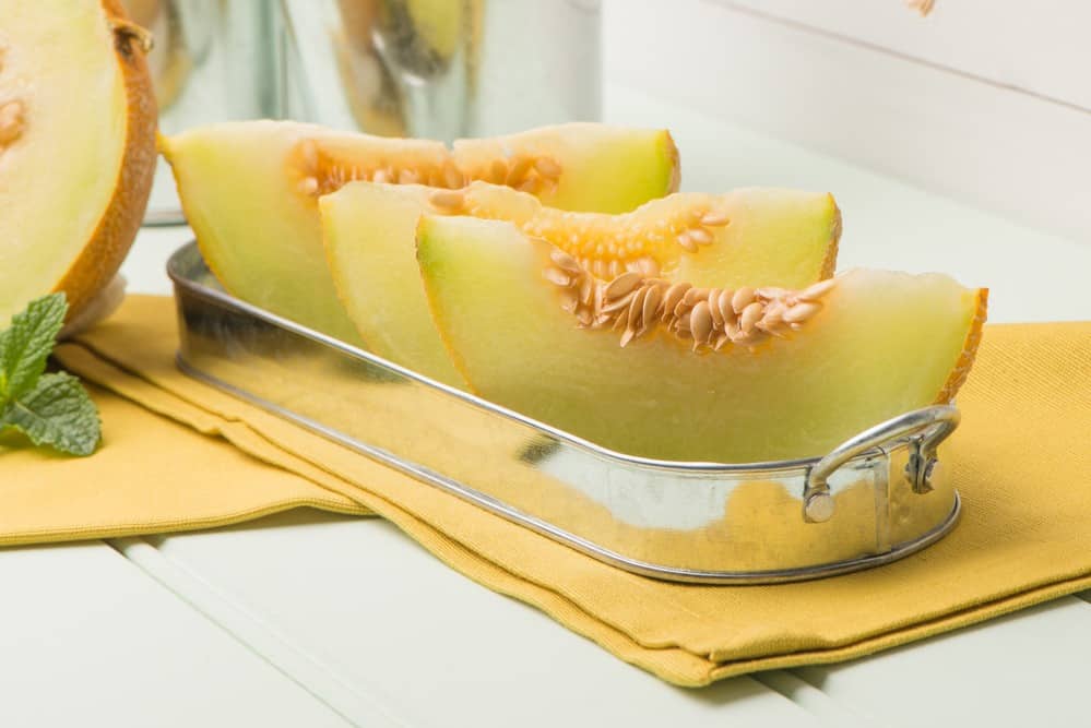 slices of honeydew melons on the tray