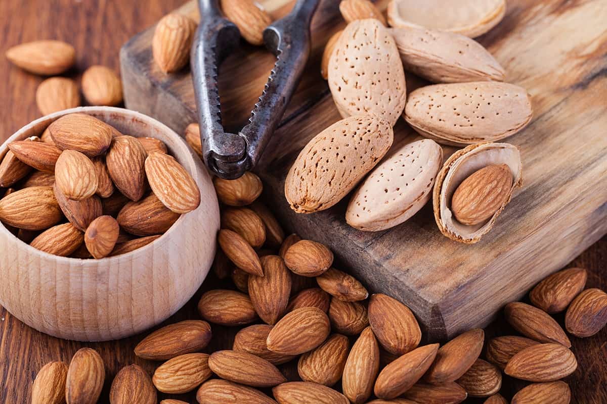 almonds on the chopping board and a bowl of almonds