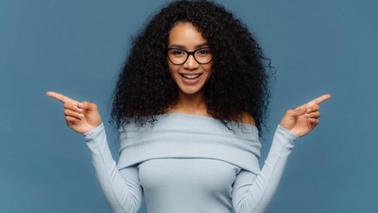 Happy excited woman pointing sideways