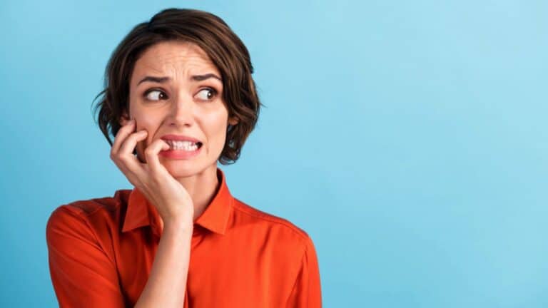 Woman biting nails scared