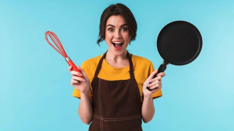 Excited woman with cooking items