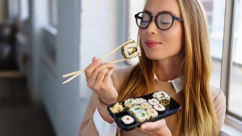 Woman eating sushi