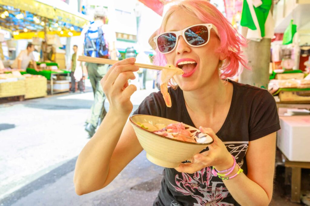 Woman eating raw fish salad sashimi