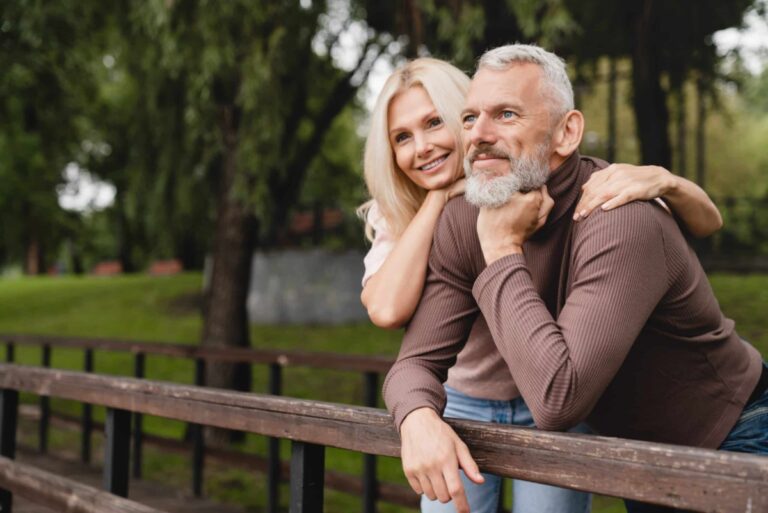 Two people looking over fence