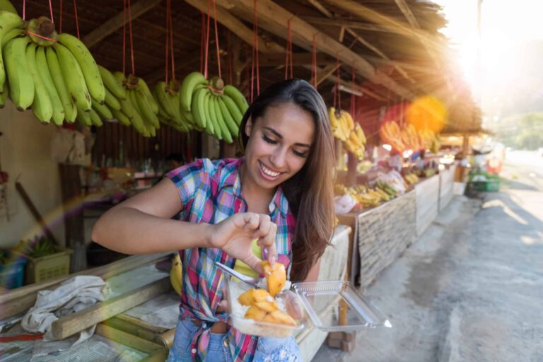 Beautiful Girl Eating Exotic Fruits Market